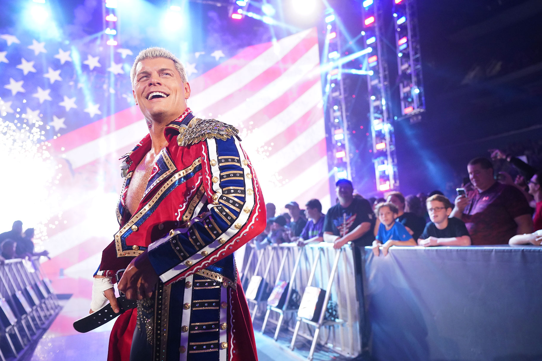 Cody Rhodes adjusting his belt outside of the ring