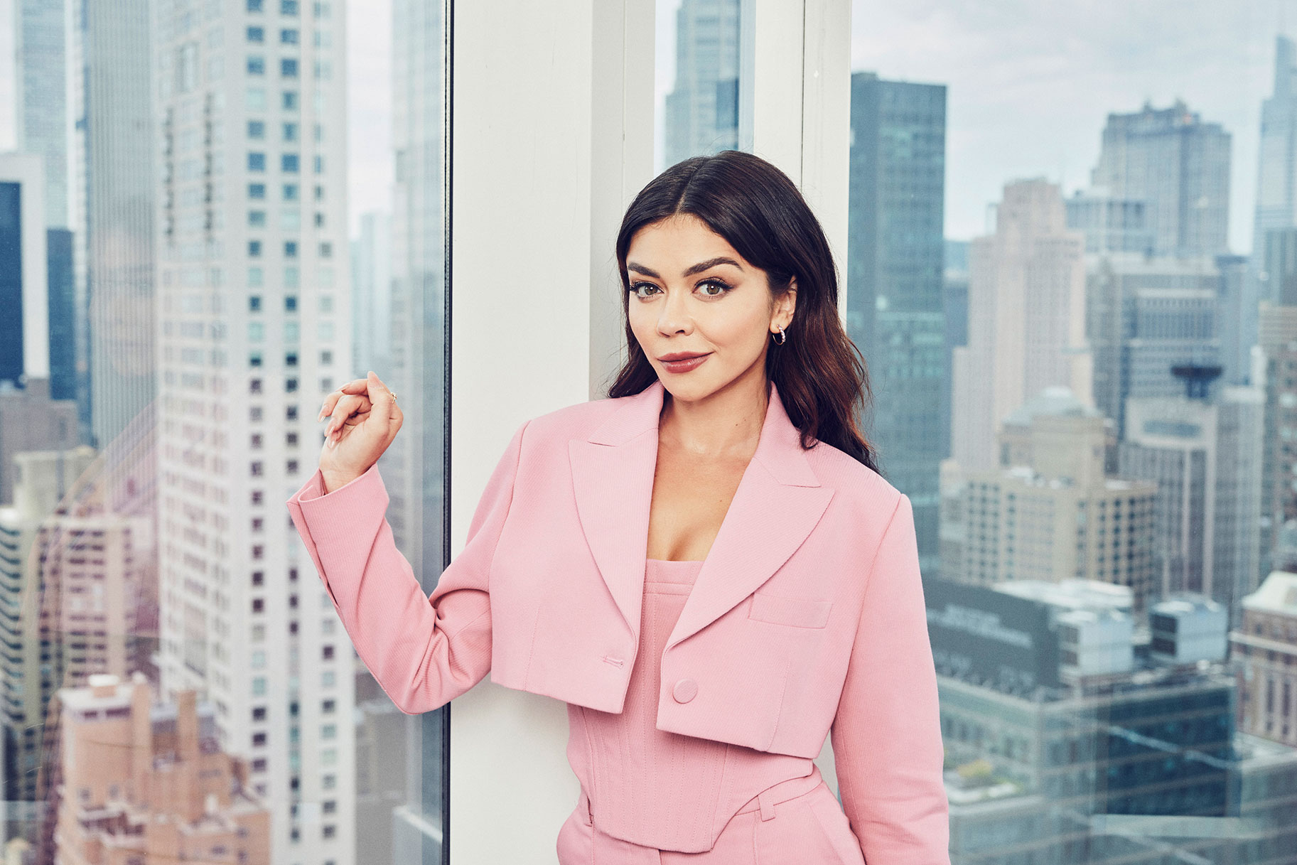 Sarah Hyland posing in front of a skyline view