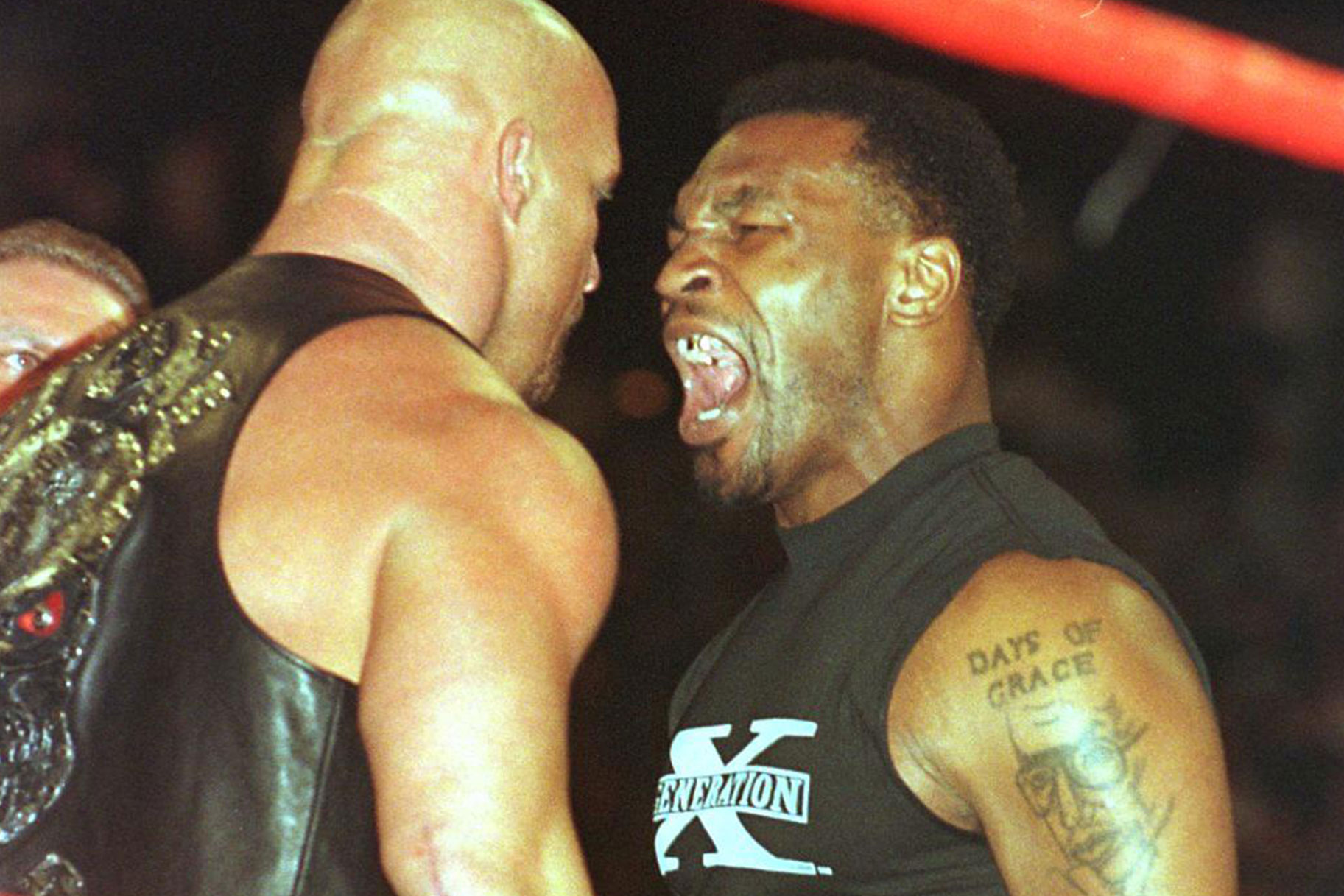 Stone Cold Steve Austin and Mike Tyson arguing in a ring