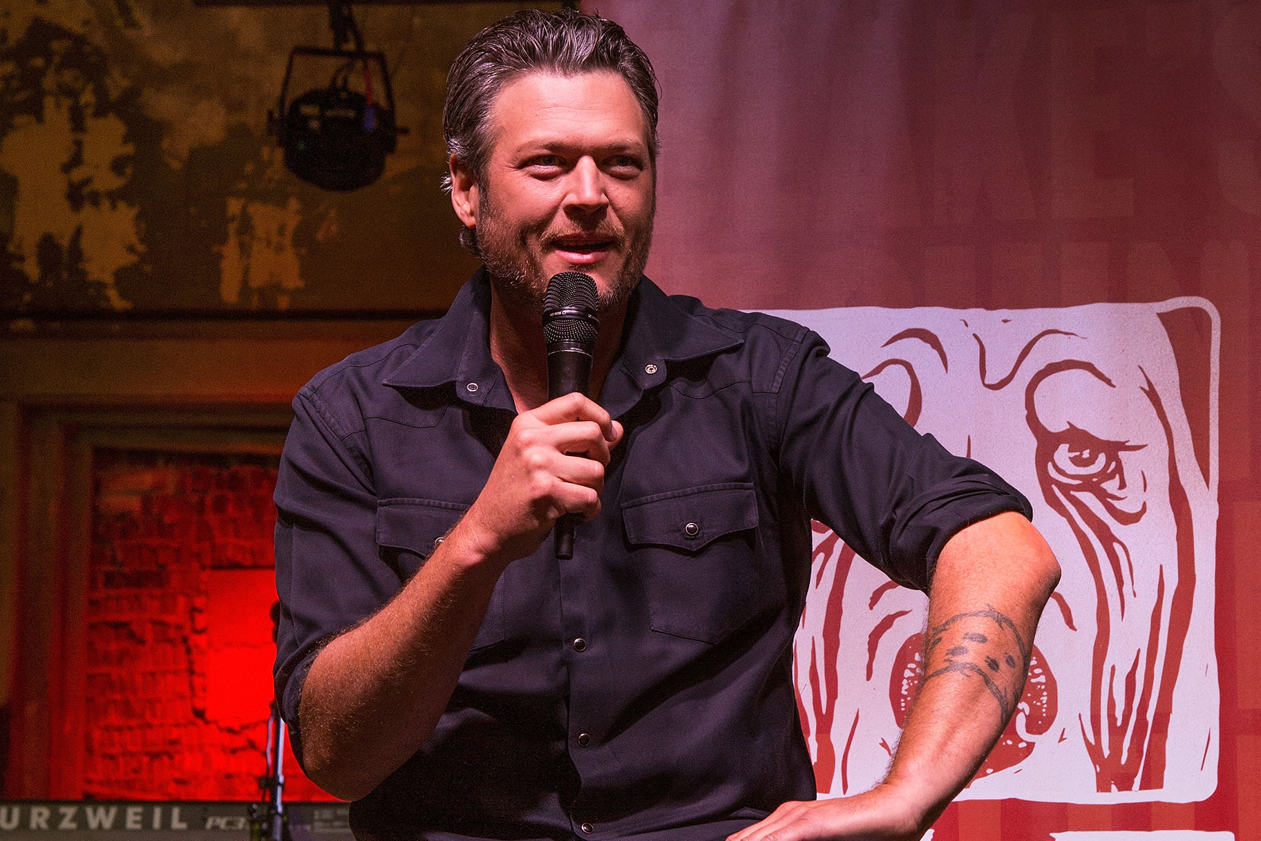 Blake Shelton sitting in his bar, Ole Red