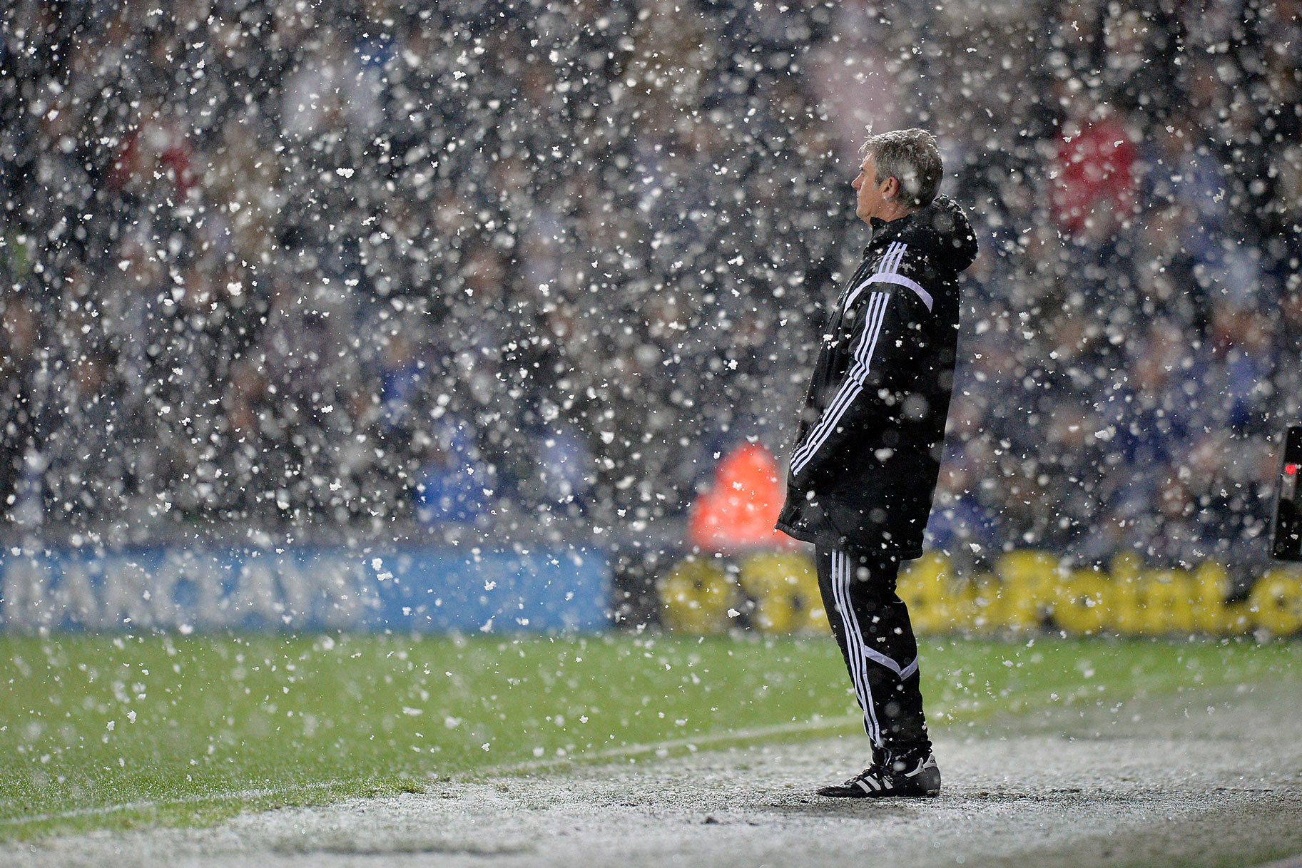 Alan Irvine head coach / manager of West Bromwich Albion watches his team play out a 1-3 defeat in the snow on Boxing Day