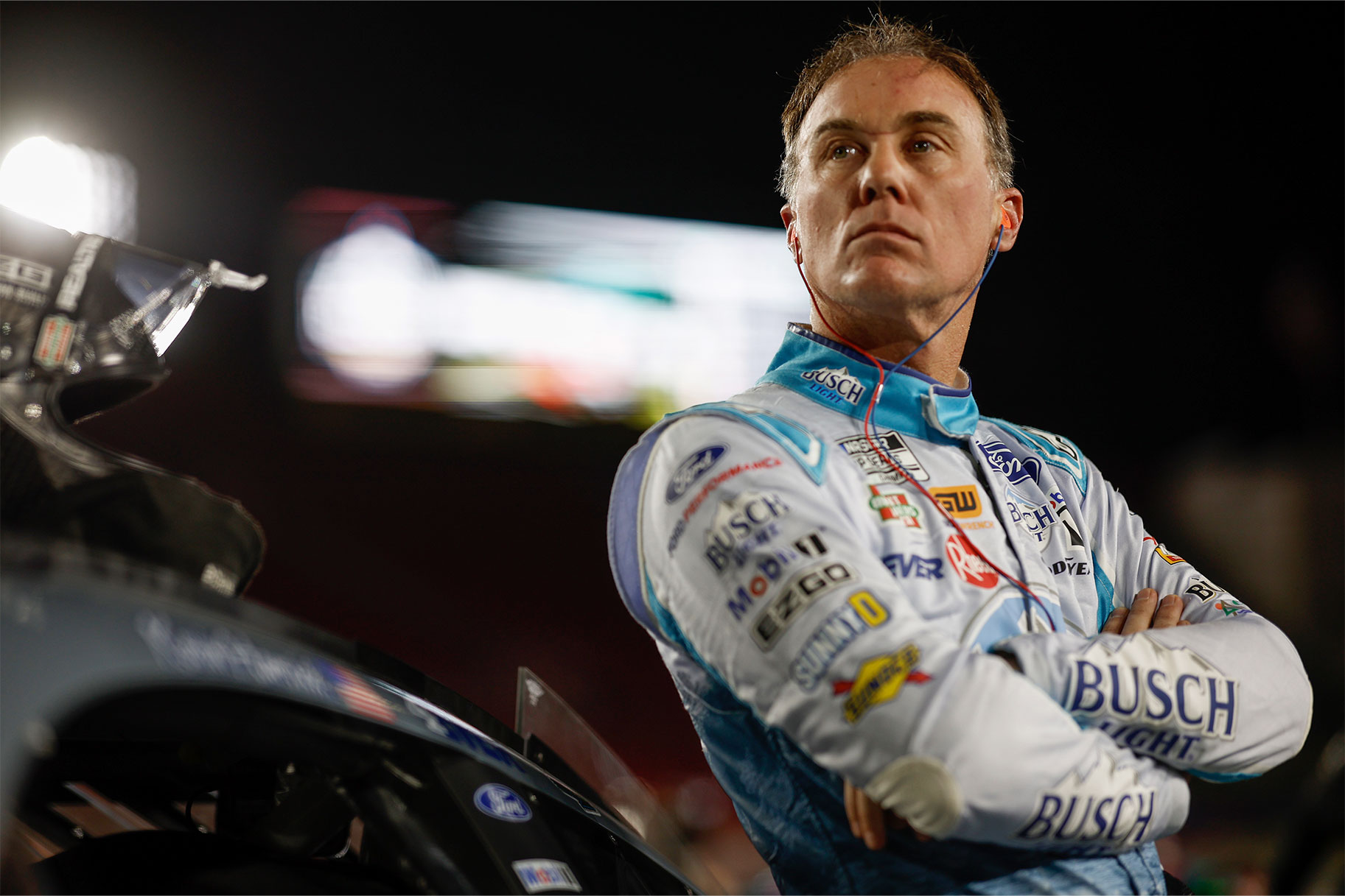 Kevin Harvick leaning against his racing car