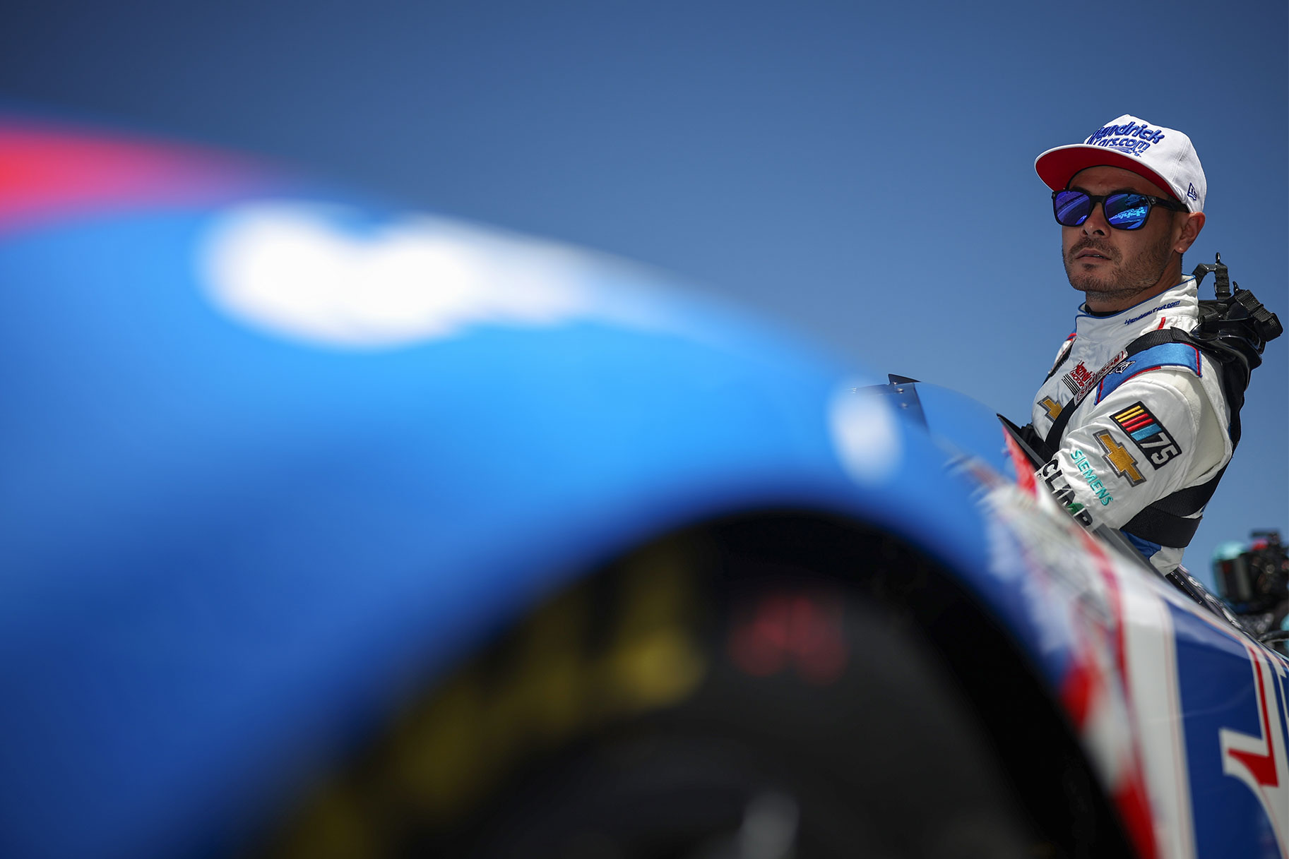 Kyle Larson enters his car during qualifying for the NASCAR Cup Series GEICO 500