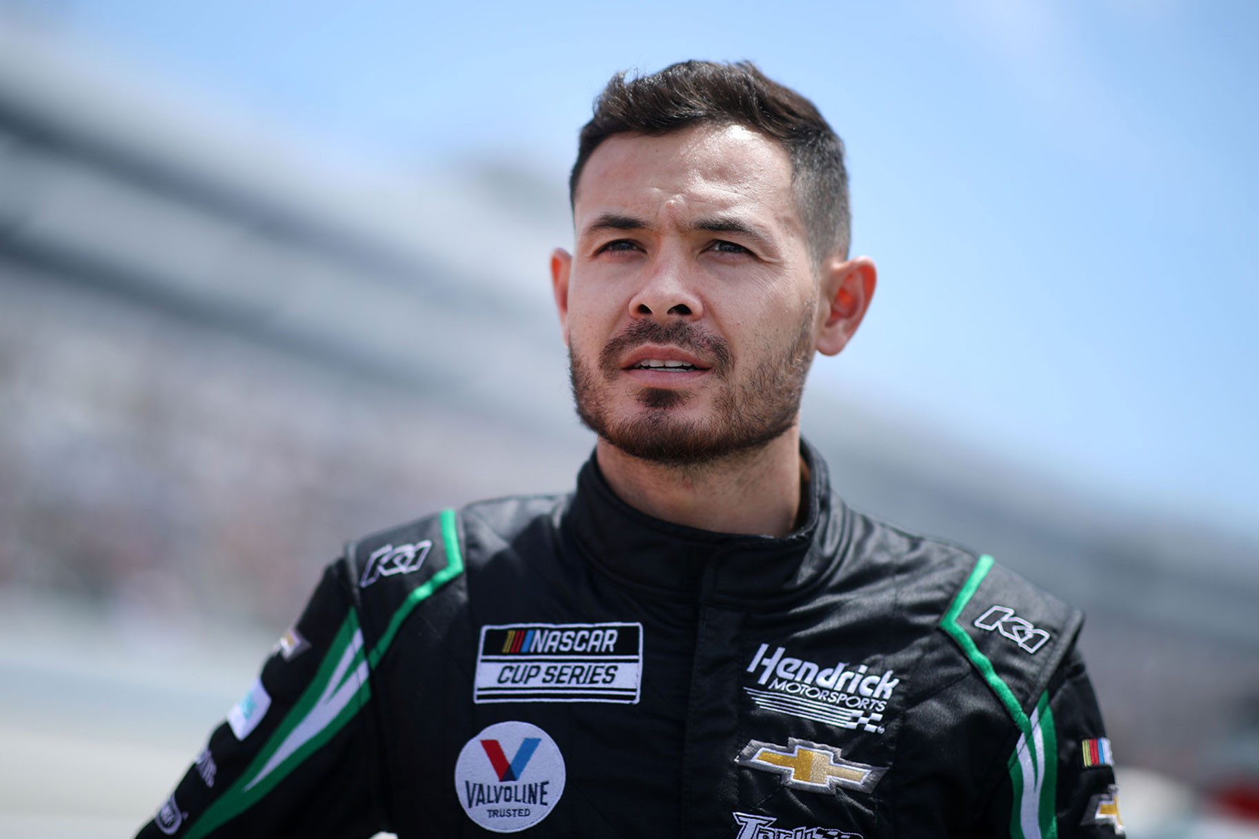 Kyle Larson looks on during a race