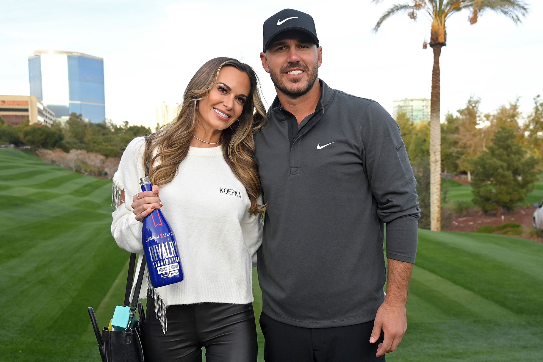 Brooks Koepka and his fiancée Jena Sims pose for photos