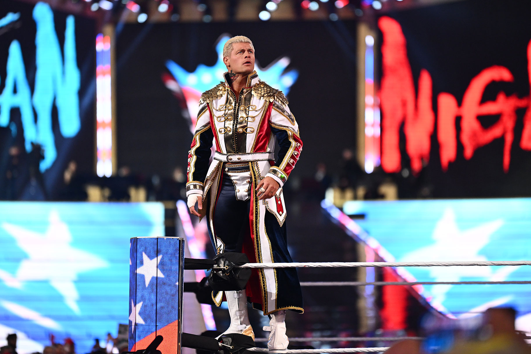 Cody Rhodes standing on the top rope of the ring.