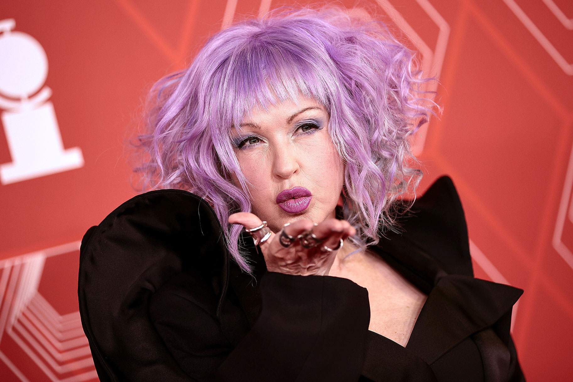 Cyndi Lauper blows a kiss to photographers on the red carpet of the Tony Awards