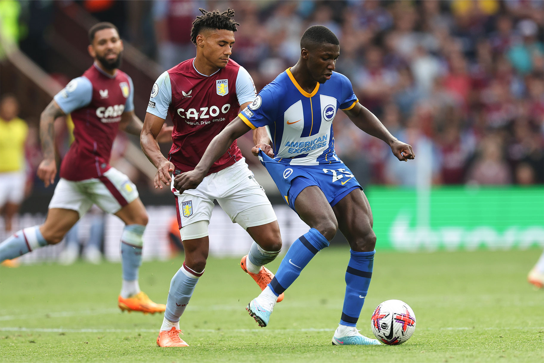 Ollie Watkins pulling on the shorts of Moises Caicedo during a match