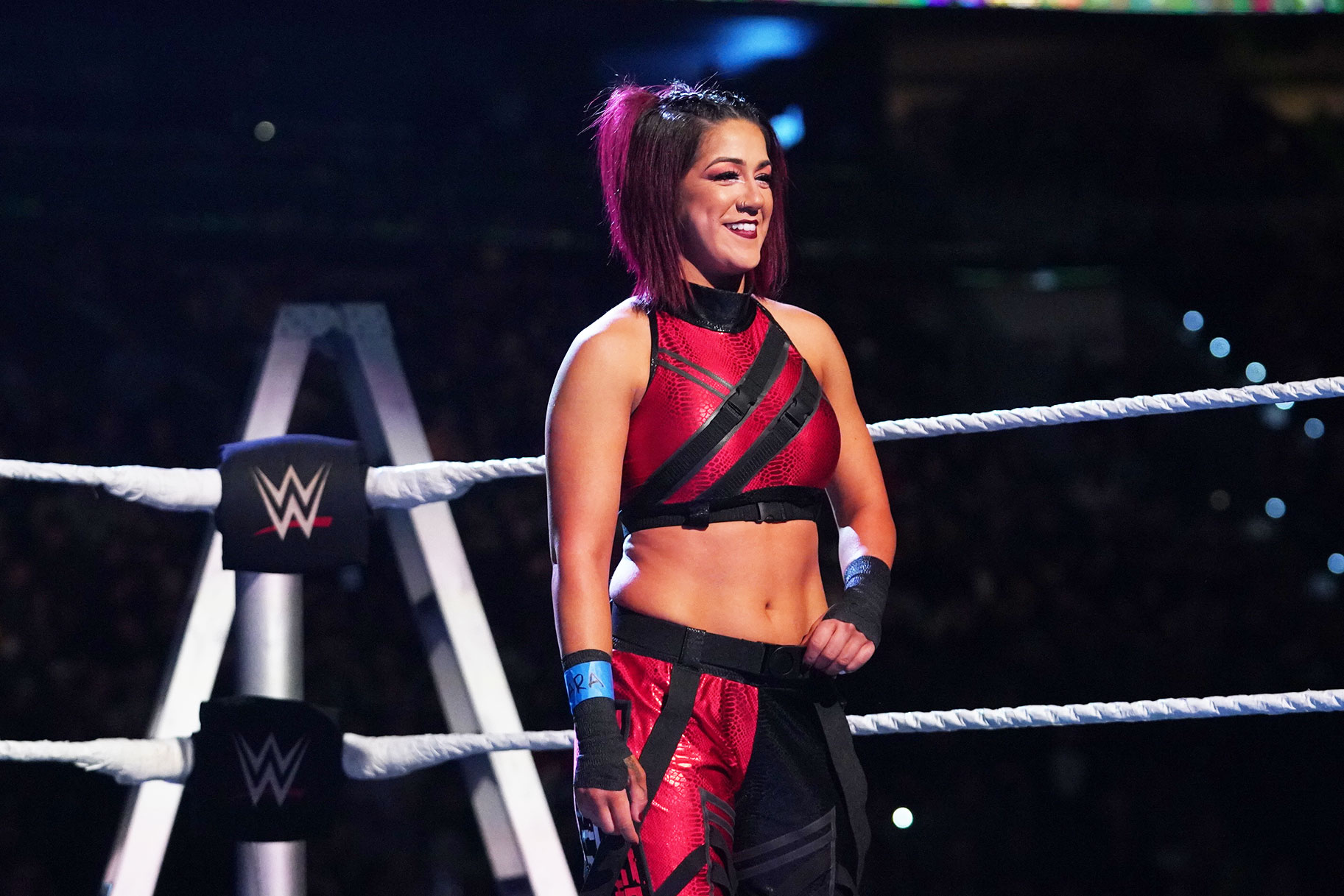 Bayley smiling as she stands in the ring