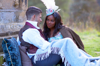 Nicole Remy sitting on grass with a suitor