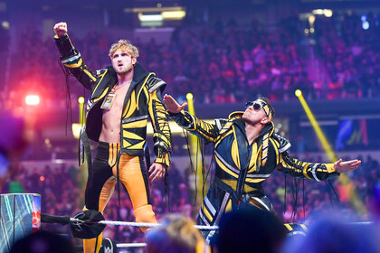 Logan Paul and The Miz posing outside of the ring