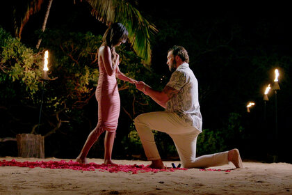 Julian Allen proposing to Kristen Ramos on a beach at night