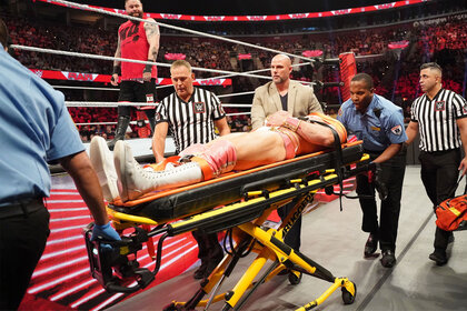 Ezekiel being wheeled away on a stretcher