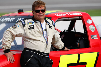 Norm Benning leaning against the side of his racecar