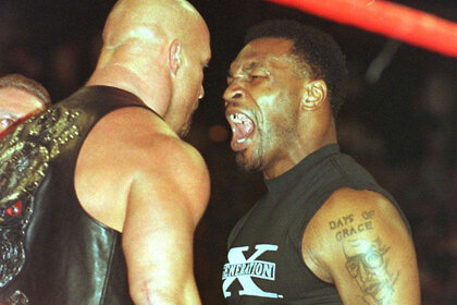 Stone Cold Steve Austin and Mike Tyson arguing in a ring