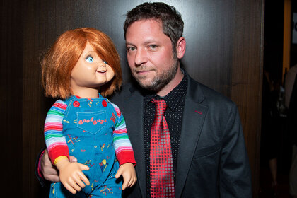 Alex Vincent holding a Chucky doll