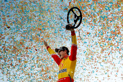 Joey Logano celebrating while confetti falls around him