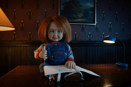 Chucky sitting on a desk