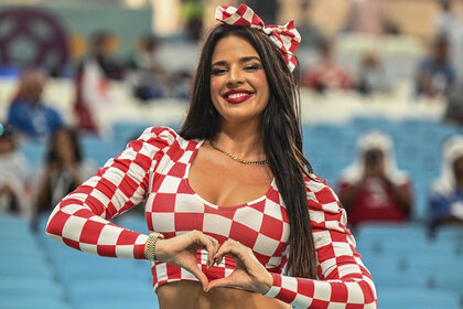 vana Knöll, a model from Croatia, poses in the stands before the match