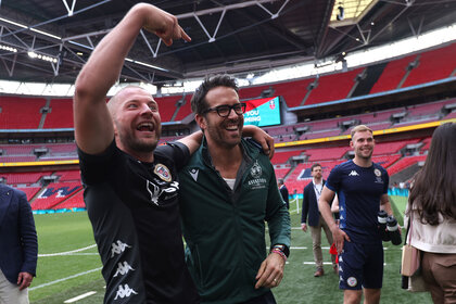 Wrexham Owner & Hollywood actor Ryan Reynolds speaks with Luke Coulson of Bromley after the final whistle as Bromley win the Buildbase FA Trophy Final between Bromley and Wrexham at Wembley Stadium on May 22, 2022