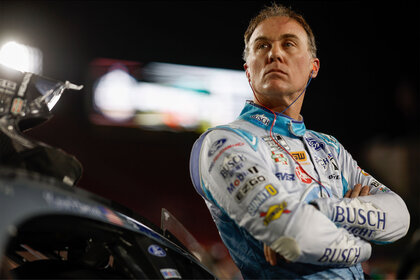 Kevin Harvick leaning against his racing car