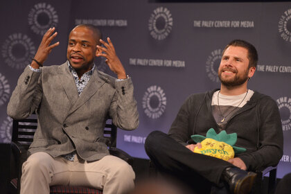 Psych actors sitting with a pineapple pliushy