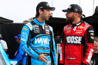 Daniel Suarez (#99 TrackHouse Racing Worldwide Express Chevrolet) talks with teammate Ross Chastain (#1 TrackHouse Racing Moose Fraternity Chevrolet) during qualifying for the NASCAR Cup Series Playoff Xfinity 500