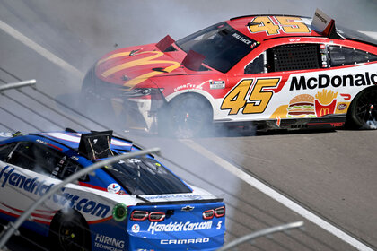 Bubba Wallace (#45 23XI Racing MoneyLion Toyota), rear, and Kyle Larson (#5 Hendrick Motorsports HendrickCars.com Chevrolet), front, crash on the front straight away during the NASCAR Cup Series Playoff South Point 400