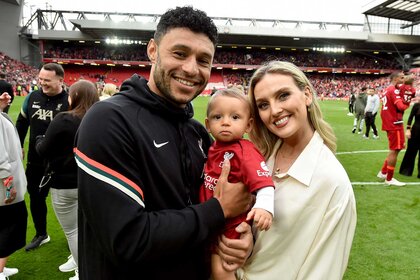 Alex Oxlade-Chamberlain of Liverpool posing for a photograph with Perrie Edwards and their baby boy at the end of the Premier League match between Liverpool and Wolverhampton Wanderers