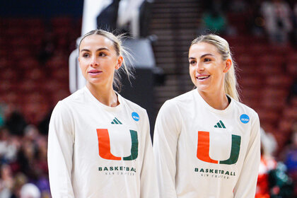 Haley and Hanna Cavinder on a baskeball court