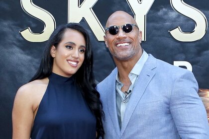 Dwayne Johnson and daughter Simone Alexandra Johnson smile for the cameras at the premiere of Skyscraper