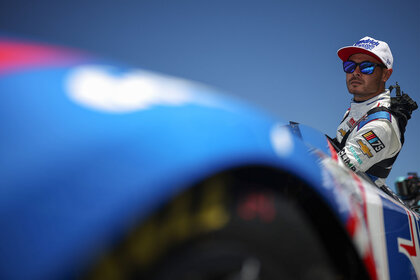 Kyle Larson enters his car during qualifying for the NASCAR Cup Series GEICO 500