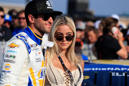 Olivia Dunne and Chase Elliot stand together smiling