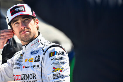 Ryan Blaney adjusts his ear piece during NASCAR Cup Series Qualifying for the Ambetter Health 400