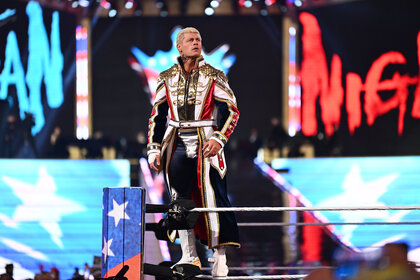 Cody Rhodes standing on the top rope of the ring.