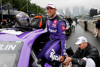 Denny Hamlin climbs into his racecar