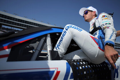 Kyle Larson enters his car before a qualifying race