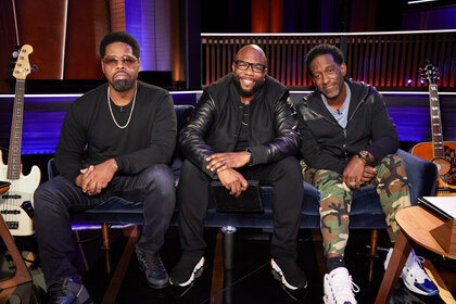 Nathan Morris, Wanya Morris, Shawn Stockman of Boyz II Men Sitting in a recording studio together.