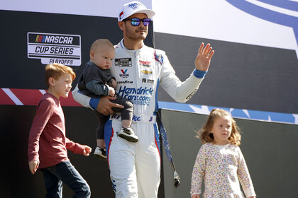 Kyle Larson, Cooper Larson, Owen Larson and daughter Audrey Larson walk onstage