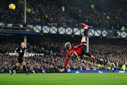 Alejandro Garnacho performs an overhead kick during a game