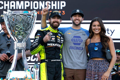 Ryan Blaney, Chase Elliott, and Gianna Tulio pose with Ryan's trophy