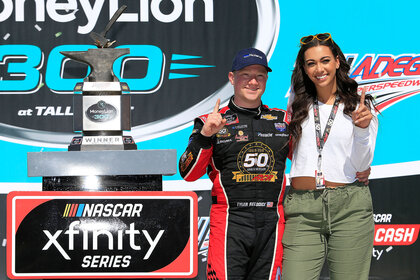 Tyler Reddick and his girlfriend Alexa Deleon celebrate winning the NASCAR Xfinity Series MoneyLion 300 race on April 27, 2019