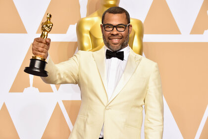 Jordan Peele poses with his Oscar in the press room during the 90th Annual Academy Awards