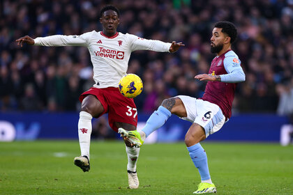 Douglas Luiz of Aston Villa in action with Kobbie Mainoo of Manchester United