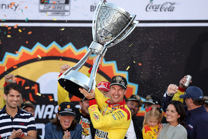 Joey Logano celebrates with the Bill France NASCAR Cup Series Championship trophy