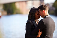 Nicole and Daniel cuddling in front of a river