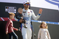 Kyle Larson, Cooper Larson, Owen Larson and daughter Audrey Larson walk onstage