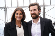 Gianna Tulio and Ryan Blaney smile for a photo on top of the Empire State Building