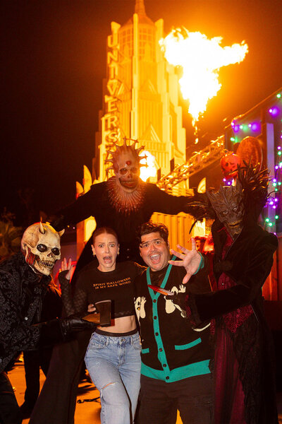 Harvey Guillen and Ariana Madix react in horror as Halloween Horror Night characters surround them