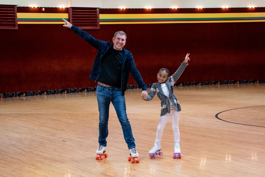 Todd and Chloe roller skating on a rink